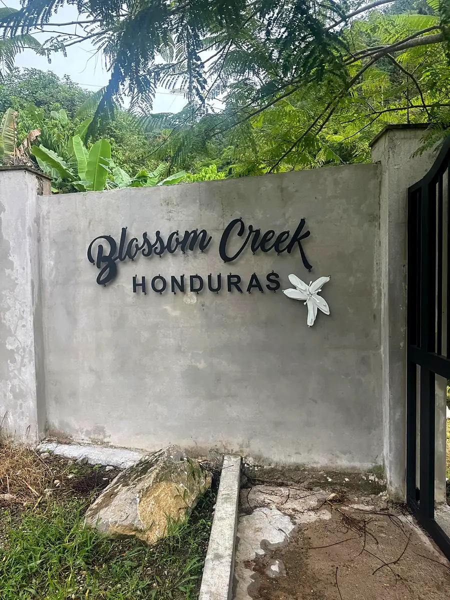 The Blossom Creek Honduras sign at the entrance to the farm